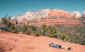 Photo of a young hiker laying down on the trail